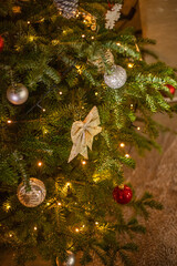 Wall Mural - The Christmas tree is decorated with garlands of bows and balls.