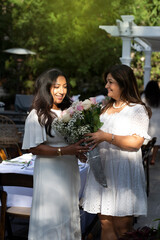 Wall Mural - Woman greeting another woman with flowers 