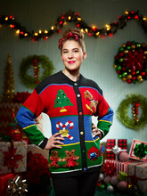 Portrait Of Woman In Ugly Christmas Sweater Looking Into Camera With Pride