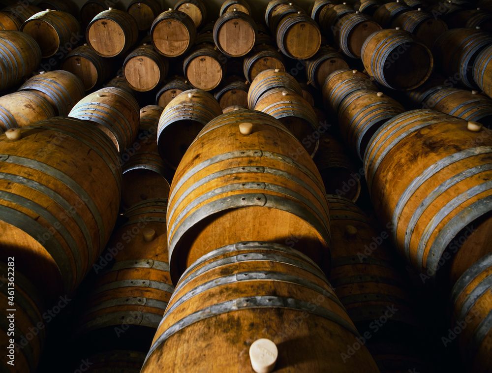 Wooden wine barrels stacked on top of each other in cellar Stock Photo ...