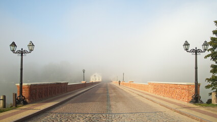 Wall Mural - Red brick bridge and mist in Kuldiga, Latvia.