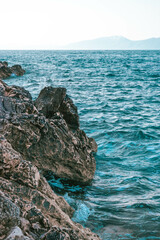 Canvas Print - Beautiful seascape with a rocky coast on the background of mountains under a clear sky