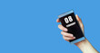 © Natalia - february 08. 08th day of the month, calendar date.Woman's hand holds mobile phone with blank screen on blue isolated background.Winter month, day of the year concept