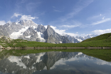 Wall Mural - Reflection of mountains and sky in the pond, in the Italian Alps