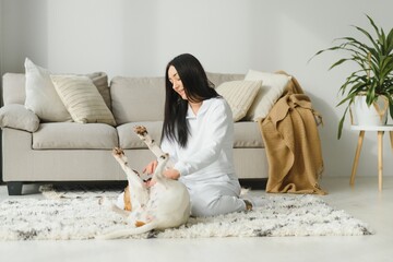 Portrait of happy woman with her dog at home