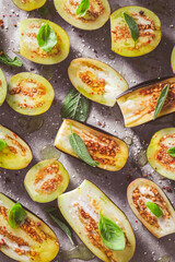 Wall Mural - Small raw eggplants prepared for baking on baking sheet