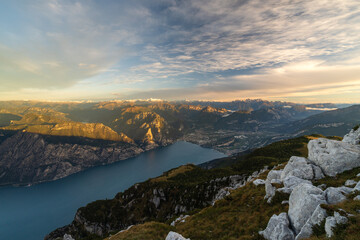 North side of lake garda at sunrise with view of the mountains and city turbel and riva del garda. Taken from mountain monte altissimo