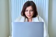 © Valerii Honcharuk - Woman working at home with laptop, warming with blanket and heating radiator