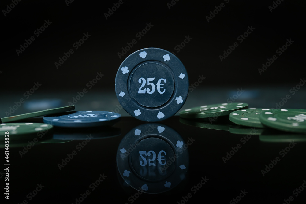 Poker chips on dark background, closeup