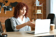 © Pixel-Shot - Young woman video chatting for online job interview at home