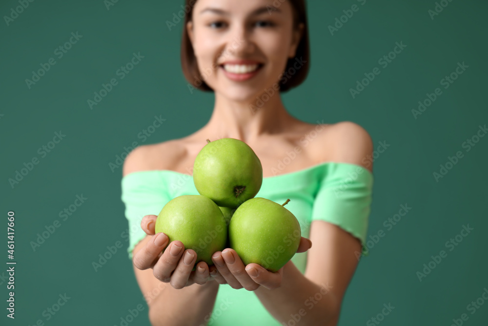 Young woman with apples on color background. Vegan Day