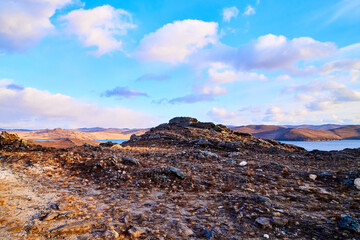 Wall Mural - Nature landscape with golden field, wather, hills and blue sky with white clouds in a day or a evening