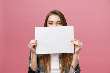 Young caucasian woman holding blank paper sheet over isolated background scared in shock with a surprise face, afraid and excited with fear expression