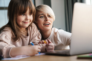 Canvas Print - Mother helping her daughter with her homework