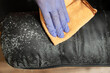© cunaplus - Cropped shot of unrecognizable man cleaning moldy couch at home
