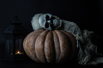 Poster - Scary skeleton on a large Halloween pumpkin in the darkness