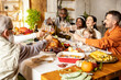 © master1305 - Happy Thanksgiving dinner party with family and friends with turkey and holiday traditional food, dishes on table.