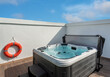© sergojpg - Luxury bathtub, jacuzzi for therapeutic massage and relaxation outside. Under the blue sky.