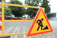 Barricade With Road Construction Sign On City Street, Closeup. Repair Works