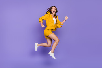 Poster - Full length photo of funny millennial lady run wear yellow suit sneakers isolated on violet background