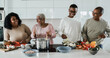 Happy black family cooking inside kitchen at home - Soft focus on boy face