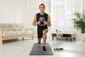 Sticker - Handsome man training with kettlebell at home