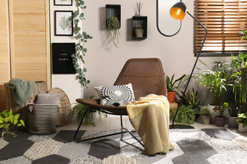 Sticker - Lounge area interior with comfortable armchair and beautiful houseplants