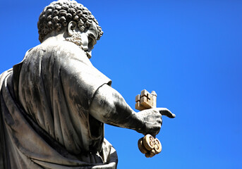 statue of St Peter in the Vatican and the hand holding the golden keys of Paradise according to the Christian tradition