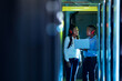 © Wavebreak Media - African american computer technicians wearing headphones using laptop working in server room