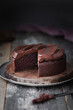 © The Picture Pantry - A frosted chocolate cake with a slice missing