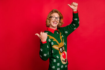 Sticker - Photo of sweet impressed young guy dressed print pullover glasses pointing looking empty space smiling isolated red color background