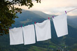 Bedclothes hanging on washing line in mountains
