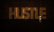HUSTLE Written in A Grungy Wall On Big Concrete dark Room With A Businessman (Hustler) Entering a Light Door. inspiration and motivation concept  