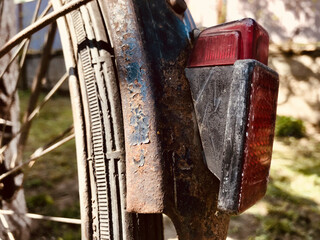 Wall Mural - Closeup of a rustic wheel and lights of a bicycle, outdoors during daylight