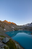 Fototapeta Natura - Wonderful scenery at an alpine lake called Wildsee in the canton of Saint Gallen. Epic sunset in the alps of Switzerland. Beautiful view with the tent in front and a perfect camping day.