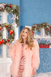 © Olena_Molchanova - smiling blonde woman in evening dress over christmas tree outdoor background