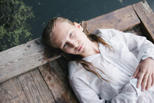 Blonde Teenage Girl  In White Shirt With Wet Hair Lie By The Lake