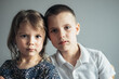 © Cavan Images - Portrait of serious brother and sister.