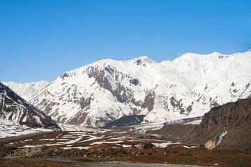 Wall Mural - Mountain natural landscape. Snow caps of the mountain tops. Rocky rocks. Crumpled landscape