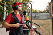 © Roman - Side View On male Looking at side after shooting. Firearms for sports shooting, hobby.strong confident man in goggles, headset hold weapon. purpose and success. man ready to fire. hunter hobby.