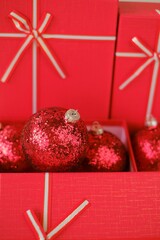 Sticker - Cristmas presents. Red boxes and Christmas balls on a light beige background. Merry Christmas. Gifts for the winter holidays.Festive christmas background in red beige colors