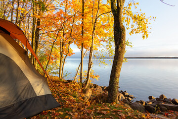 Waterside campsite in autumn with beautiful fall colors