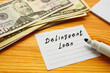 Business concept about Delinquent Loan with sign on the page.
