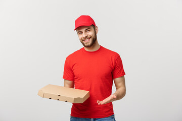 Wall Mural - Delivery Concept: Young haapy caucasian Handsome Pizza delivery man holding pizza boxes isolated over grey background