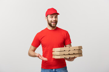 Wall Mural - Delivery Concept: Portrait of Pizza delivery man presenting something in box. Isolated white background.