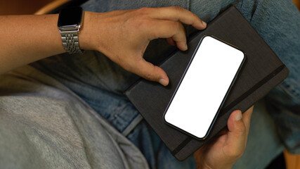 Close-up A hipster man with mobile phone. smartphone blank screen mockup