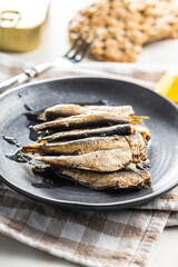 Wall Mural - Smoked sprats on plate. Canned sea fish.