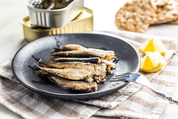 Poster - Smoked sprats on plate. Canned sea fish.