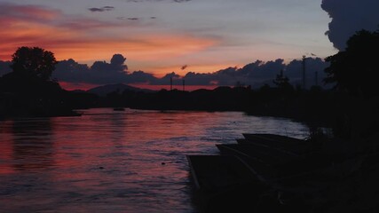 Poster - River at sunset with beautiful colors on the background.