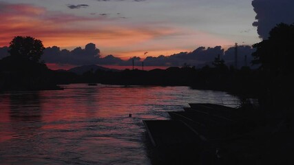 Poster - River at sunset with beautiful colors on the background.